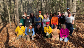 Group photo in woods of people wearing PPE