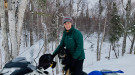 Donna Massay on her snow machine with her dog 