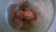 Image of ripe persimmons in a cone shaped colander