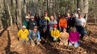 Group photo in woods of people wearing PPE